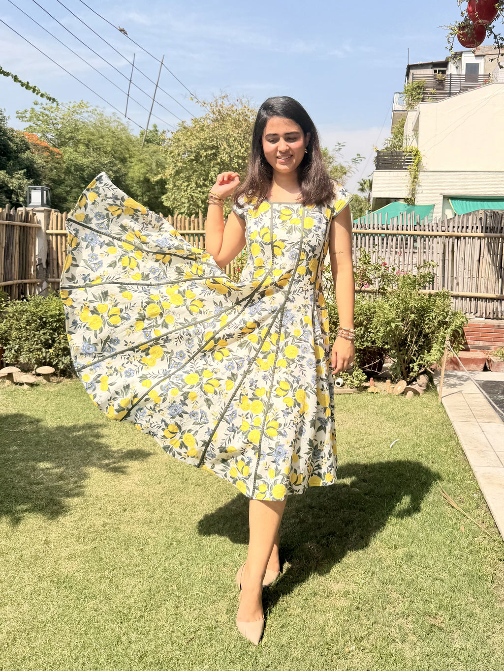Flowy panelled cotton dress with citrus floral print wide flare detail