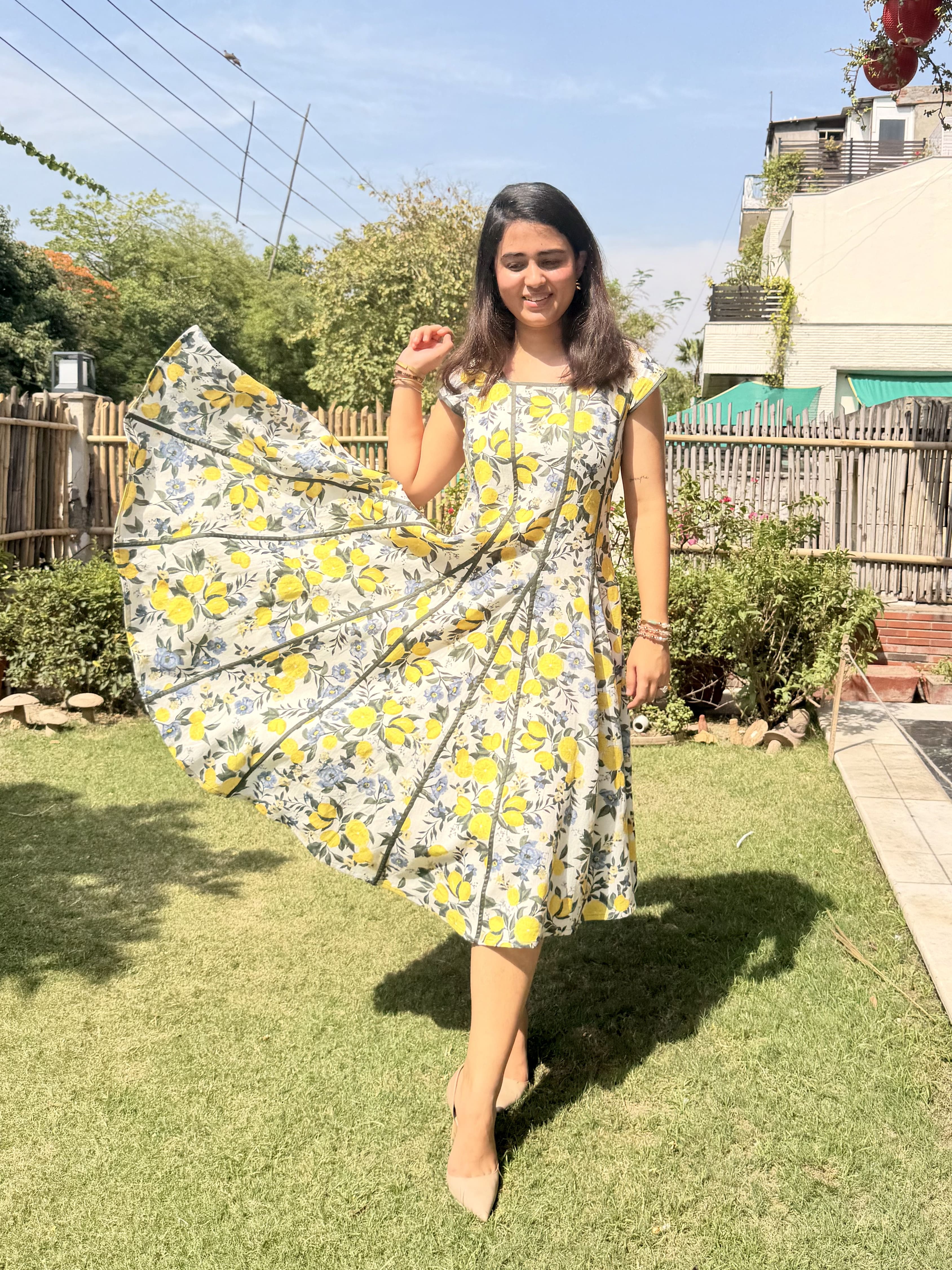 Flowy panelled cotton dress with citrus floral print wide flare detail