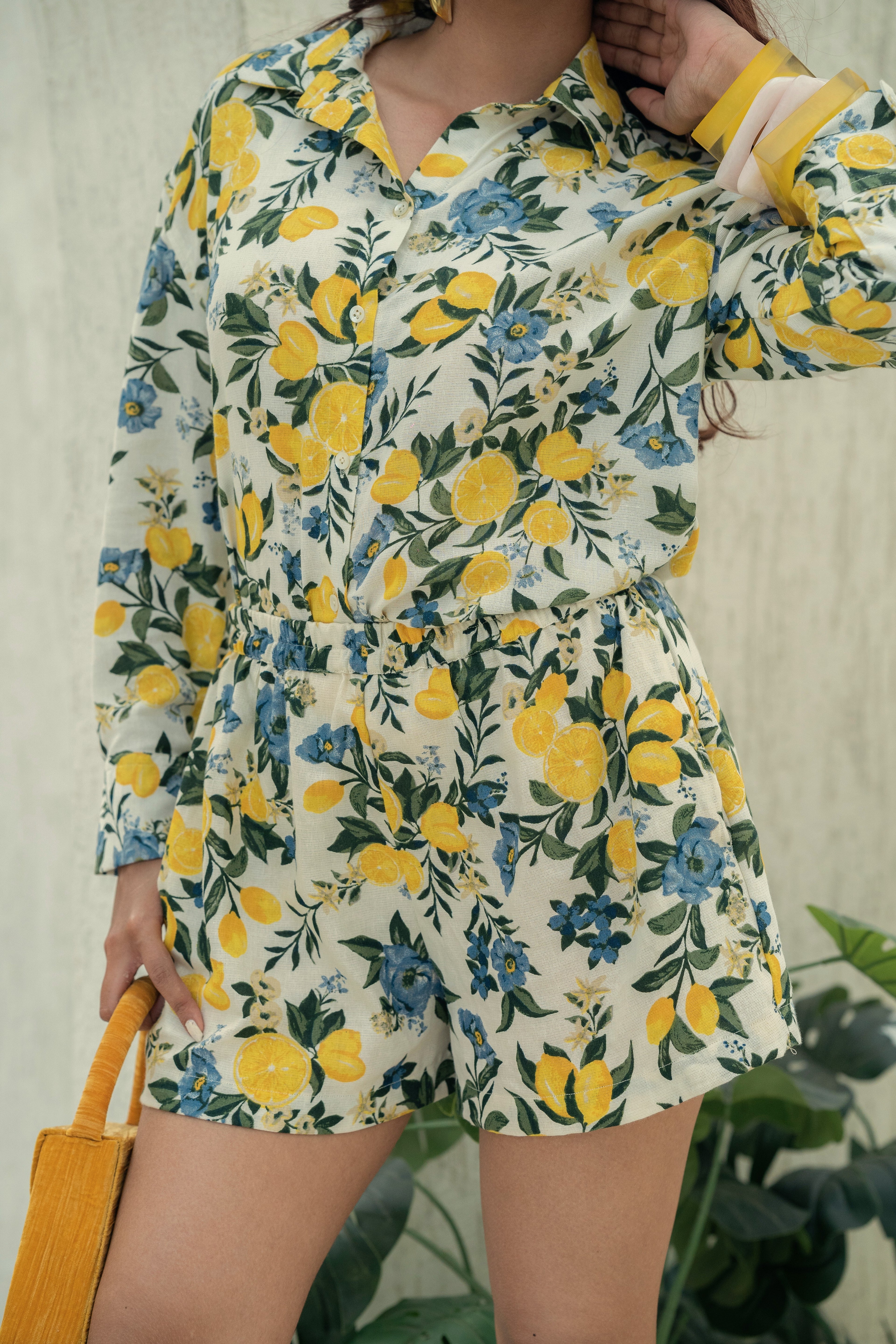 Person wearing aCitrus Bloom Oversized Shirt & Shorts Co-ord Set – Printed Cotton Flax Resort Wear with floral and lemon pattern against a neutral background