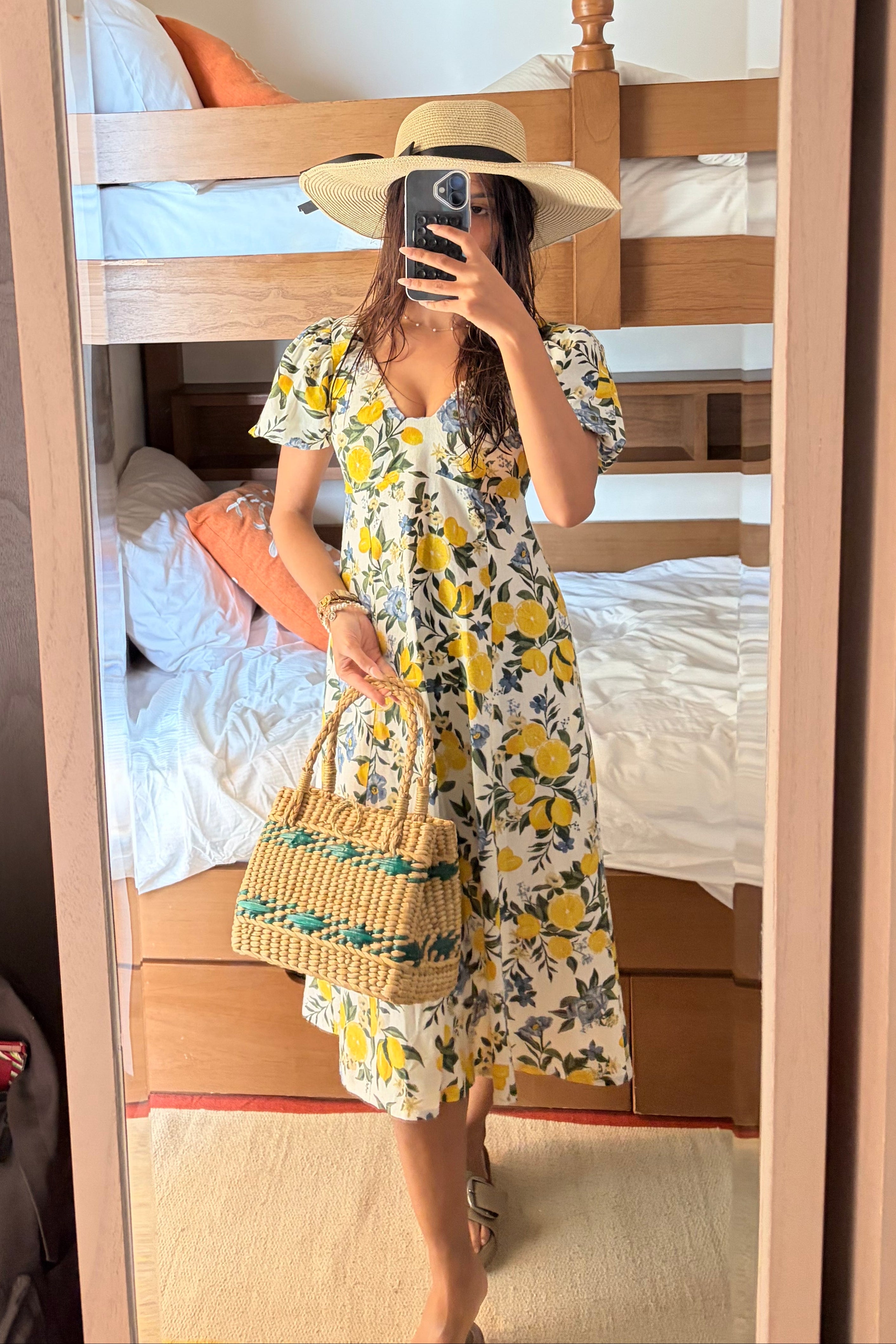 Client wearing a Citrus Bloom Puff Sleeve Dress – Printed Cotton Flax standing in front of a mirror.