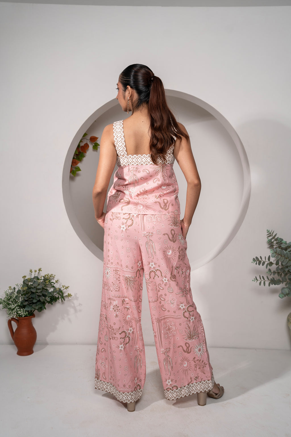 Woman wearing aDesert Rose Pink Printed Cotton Co-ord Set – Vacation & Resort Wear outfit with a white circular frame in the background