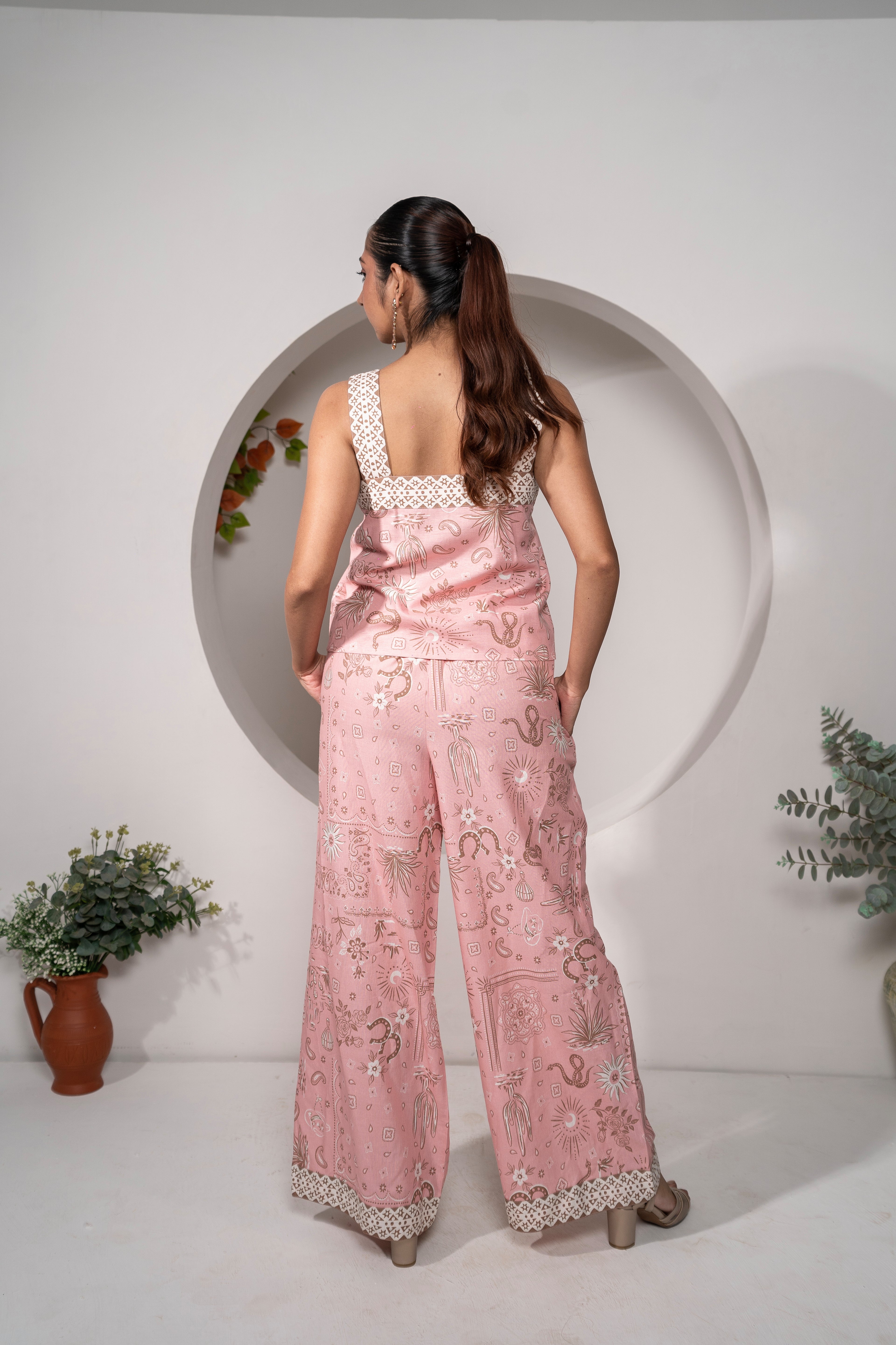 Woman wearing aDesert Rose Pink Printed Cotton Co-ord Set – Vacation & Resort Wear outfit with a white circular frame in the background