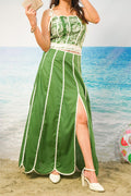 A woman wearing a Kavya Cotton Cambric Scalloped Co-ord Set with a high slit, standing on a sandy beach with the ocean in the background.