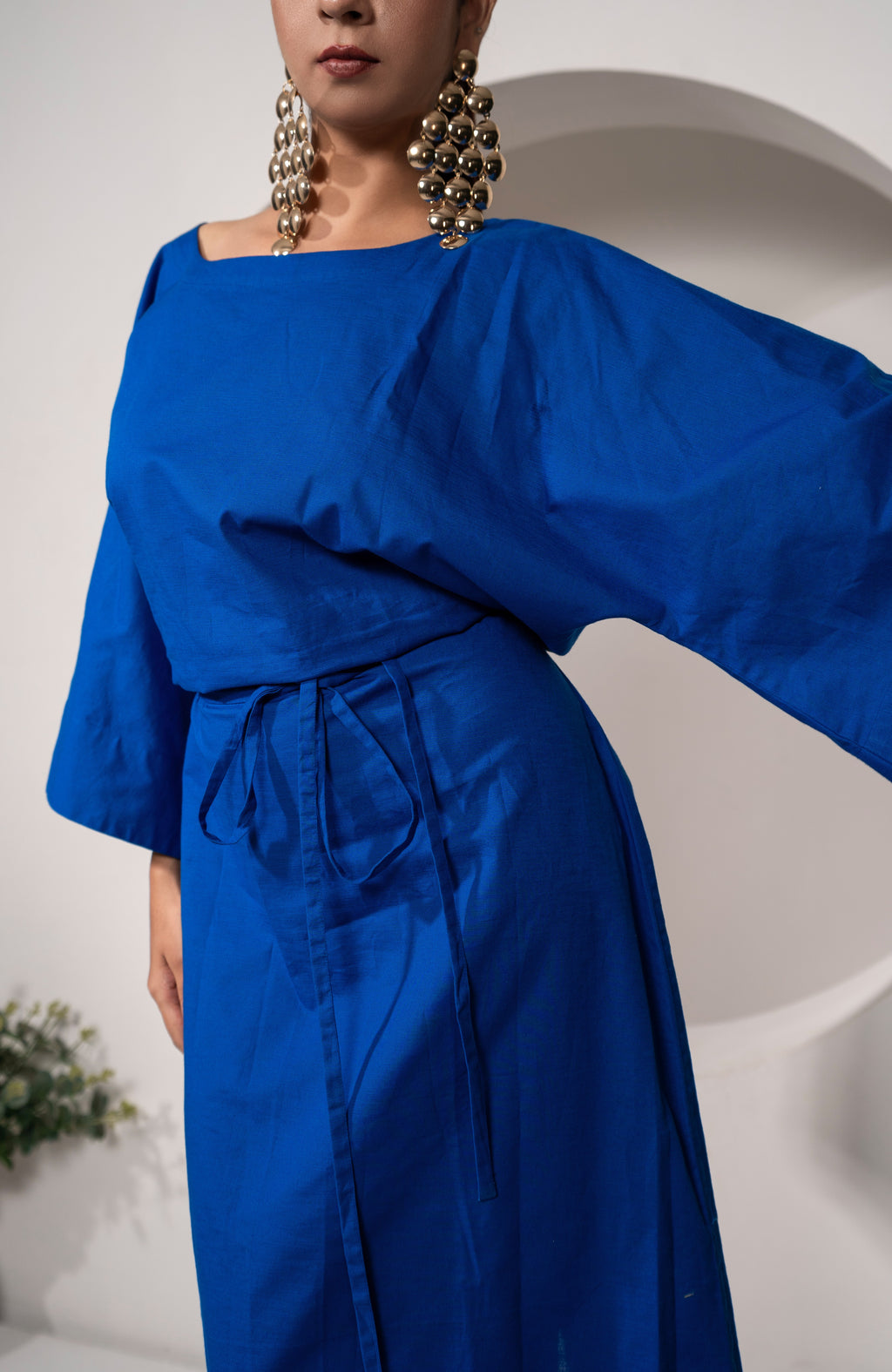 Person wearing a Khamna's Ocean Mirage Kaftan Dress – Cotton Linen Tieable Drape with wide sleeves against a white background