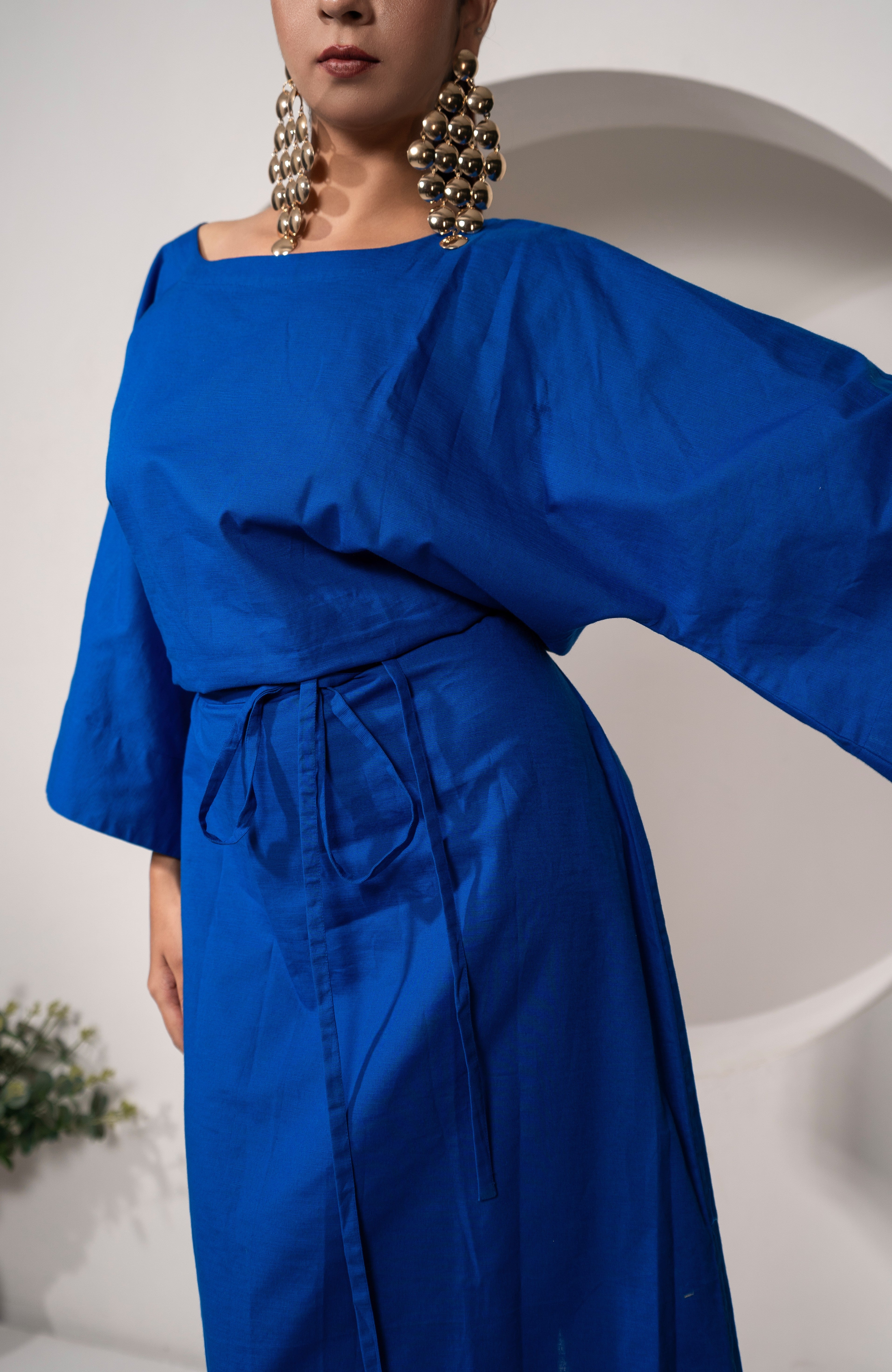 Person wearing a Khamna's Ocean Mirage Kaftan Dress – Cotton Linen Tieable Drape with wide sleeves against a white background