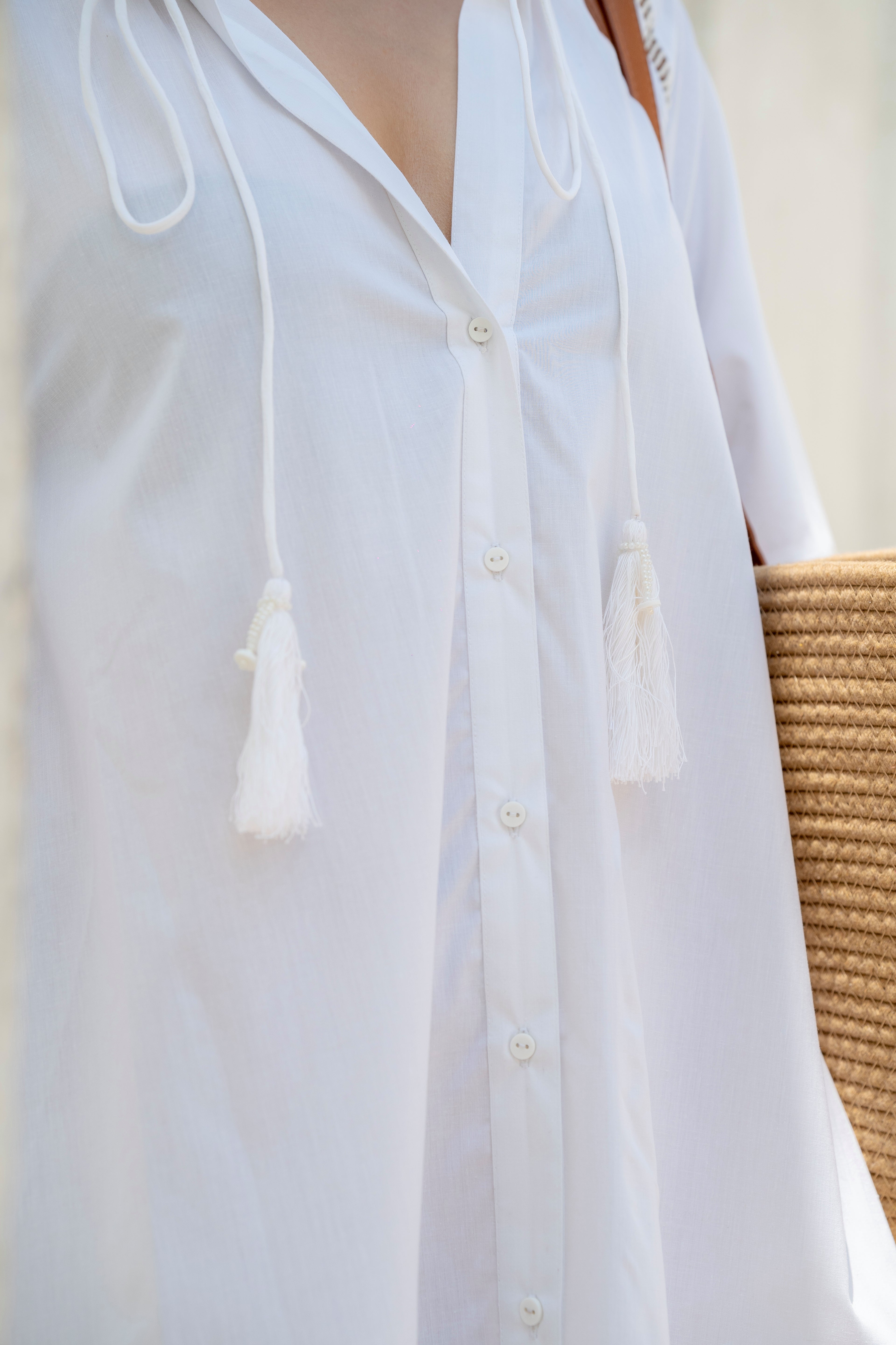 The Riviera Dress – White Cotton Poplin with Lace Detail with tassels  Handmade on a neutral background