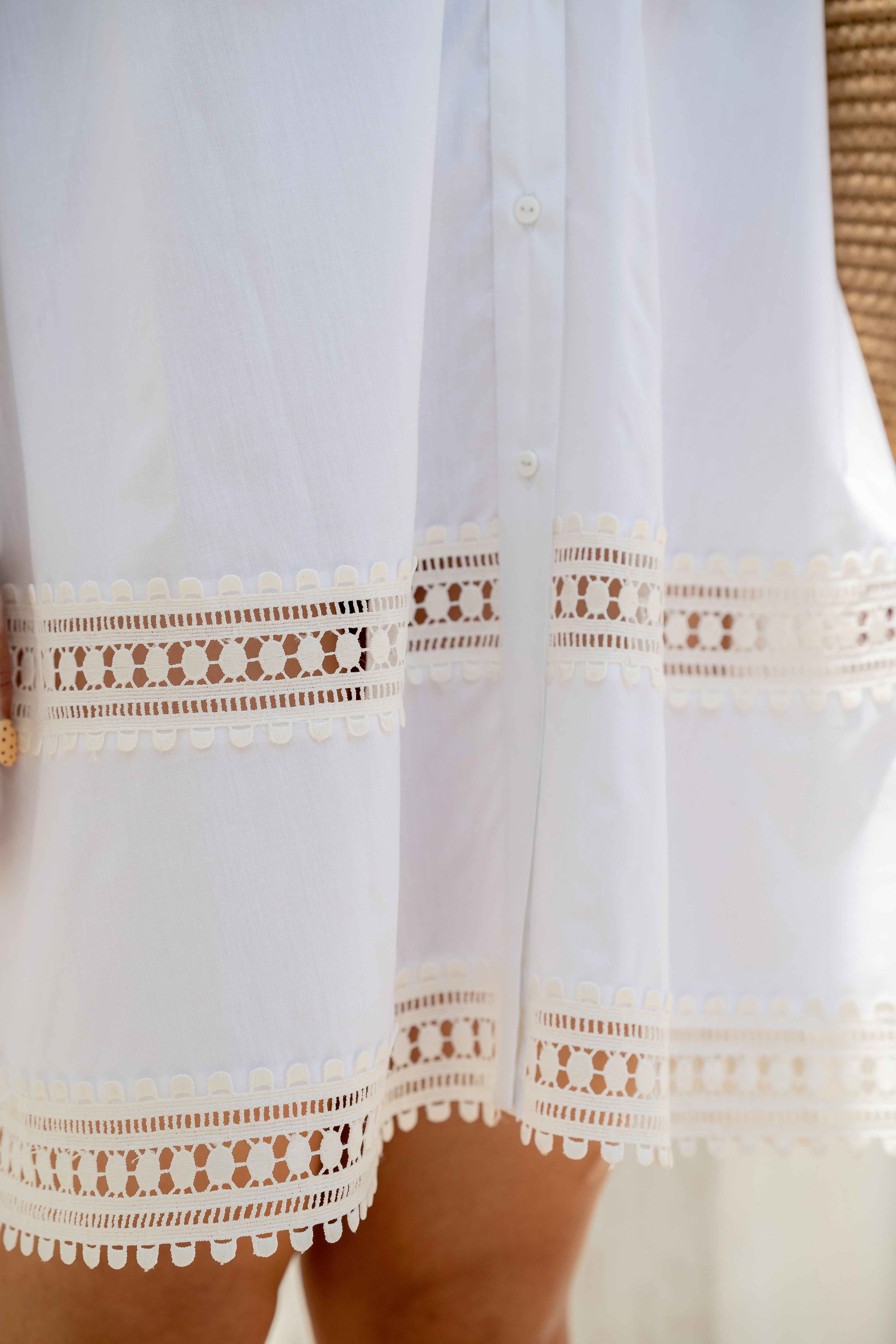 White dress with lace details on a neutral background