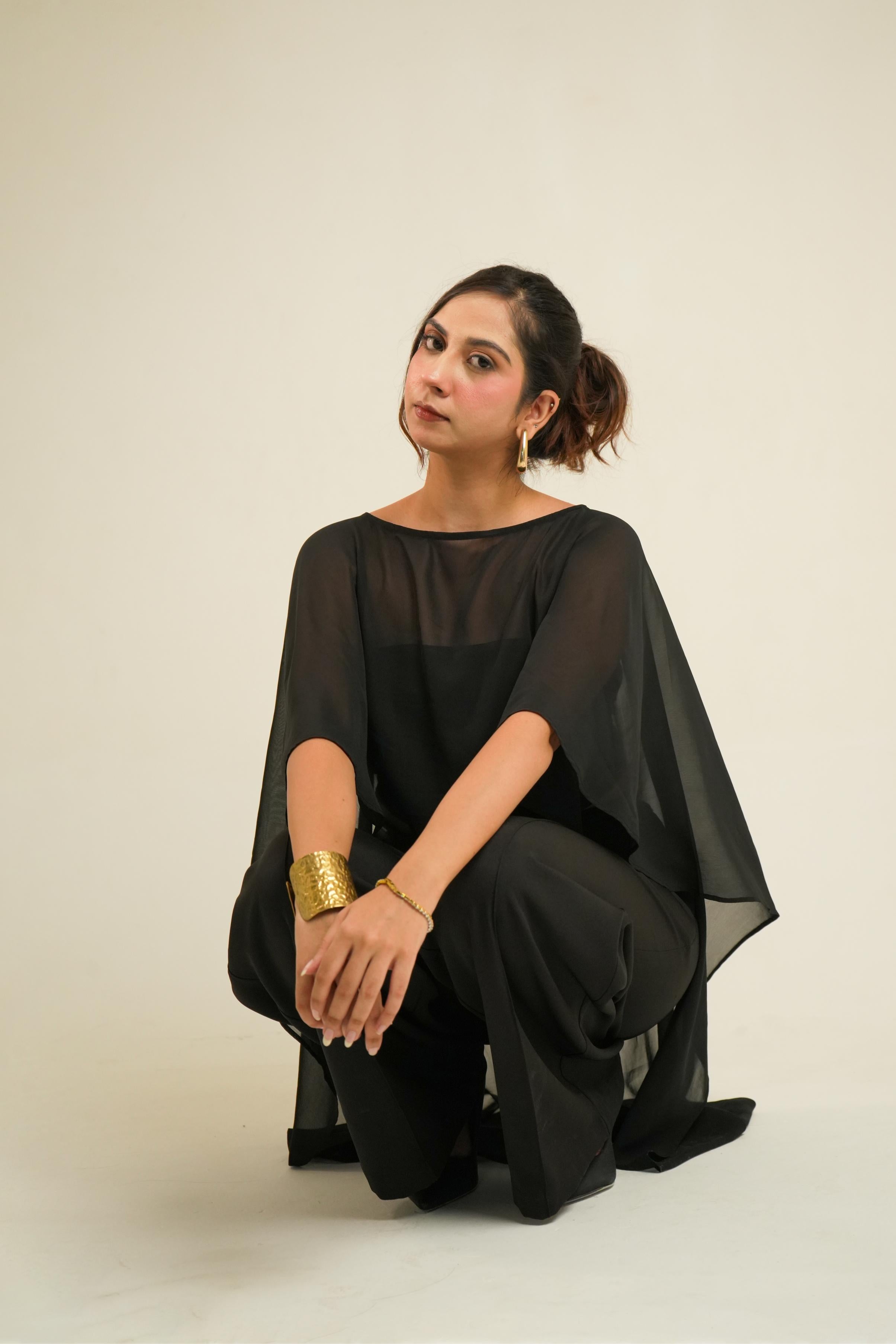 Vrinda Three-Piece Black Co-ord Set | Tube Top, Cape & Wide-Leg PantsV pose sitting and chilling