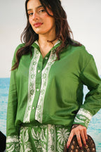 Yoshita Green Cotton Co-ord Set | Oversized Shirt & Shorts
 on a beachy backdrop and a purse. reen color set with border print
