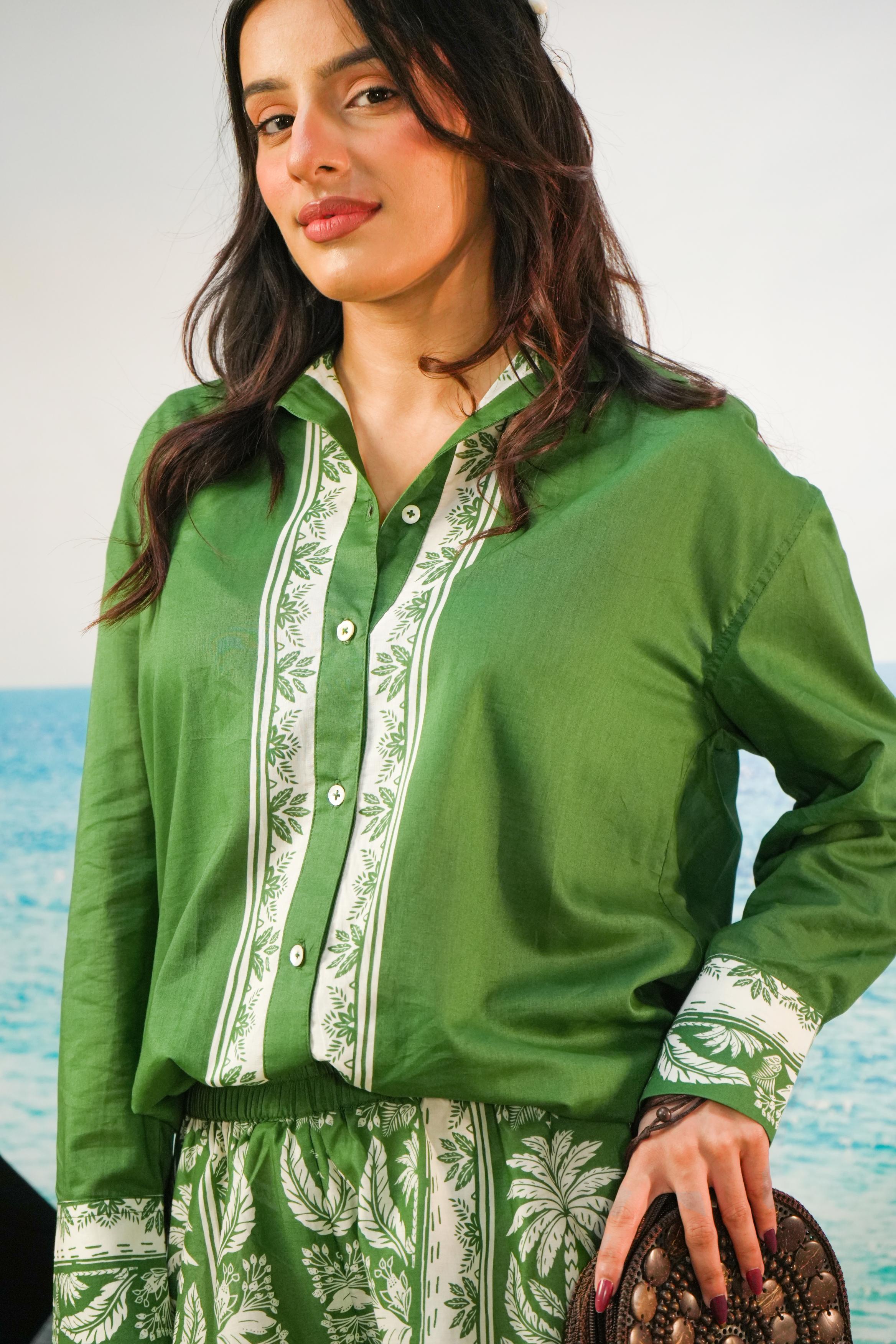 Yoshita Green Cotton Co-ord Set | Oversized Shirt & Shorts
 on a beachy backdrop and a purse. reen color set with border print