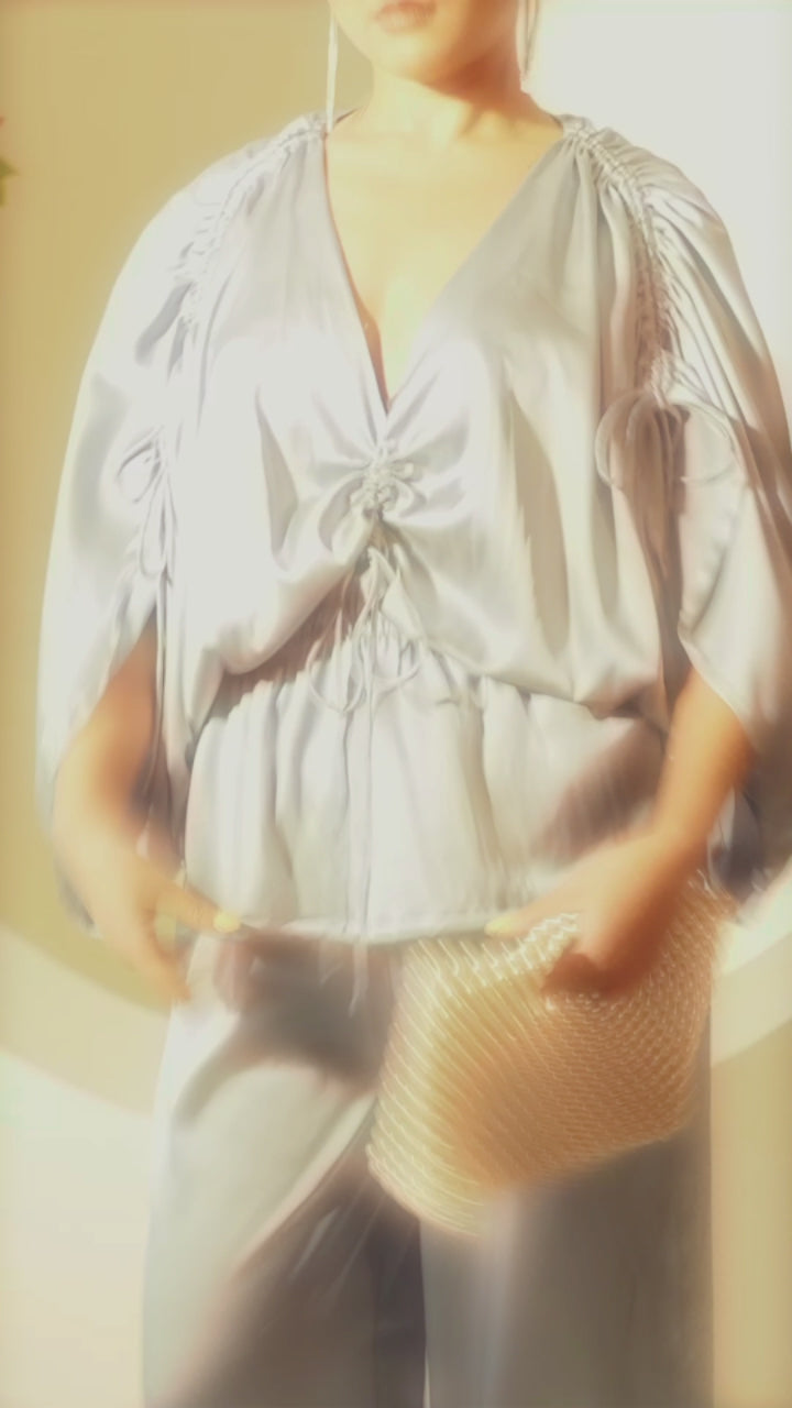 Satin ruched top in light blue with adjustable drawcord and fully elasticated waist. this rich and elegant pcs is must have this party season